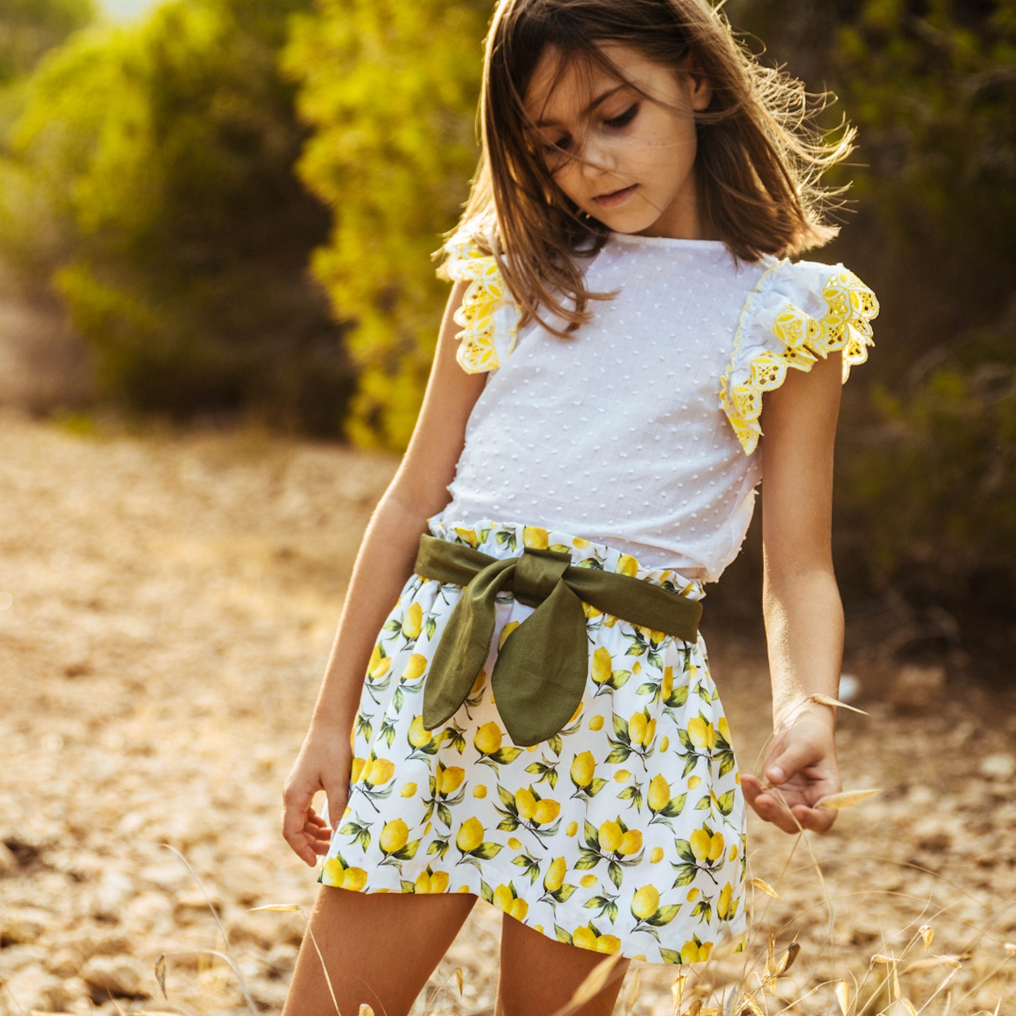 An application scenario or product detail of teen frock elastic top part in yellow - Image 9